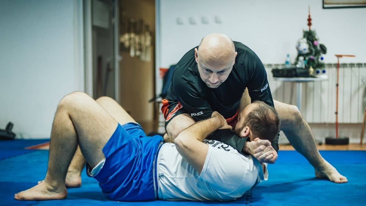 MMA students practicing a neck crank on the mat