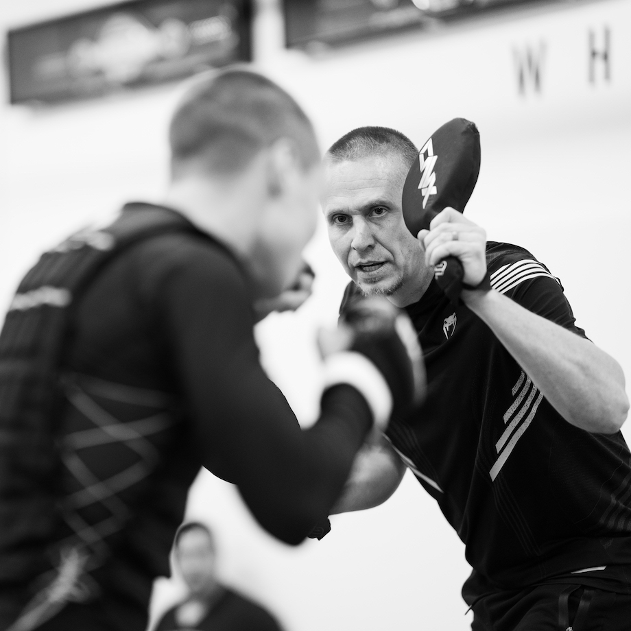 Trevor Wittman holding boxing padels for Rose Namajunas