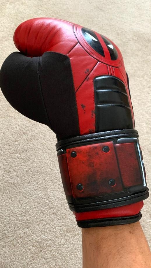 Slightly angled backhand view of wearing a strapped Hayabusa Marvel boxing glove