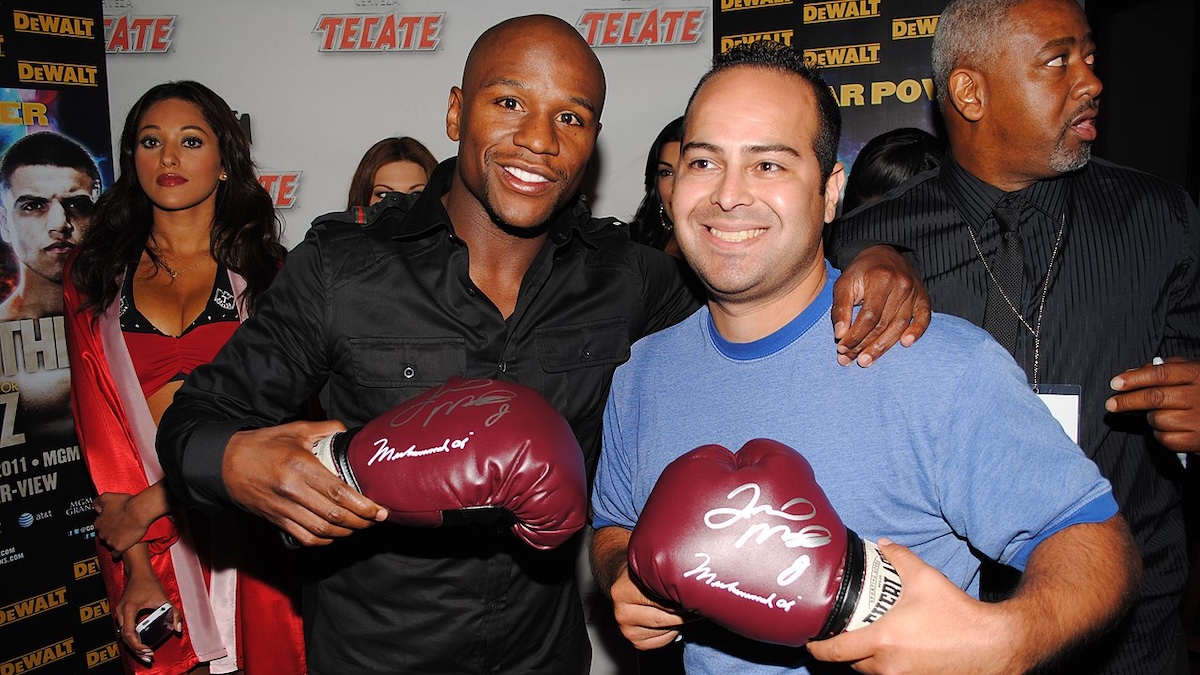 Floyd Mayweather posing with signed boxing gloves