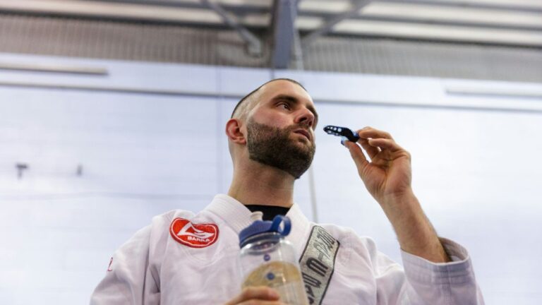 bjj student placing in mouthguard before practicing alone