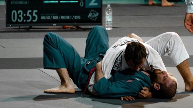 two jiu jitsu competitors in a sparring match on the mats