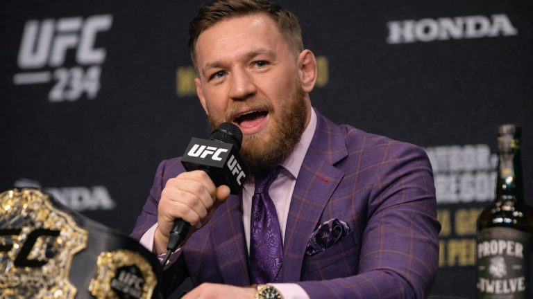 conor mcgregor speaking on the mic at a ufc press conference